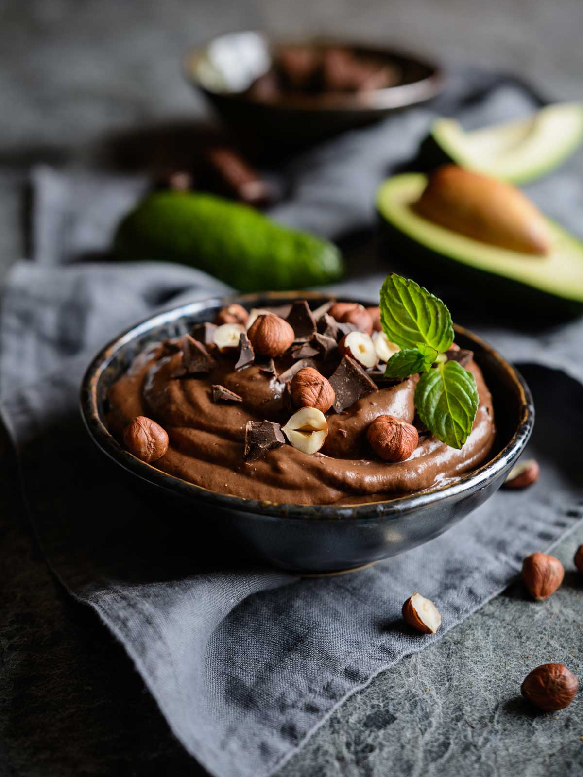 creamy chocolate avocado mousse made with unsweetened hazelnut milk and hazelnuts on top