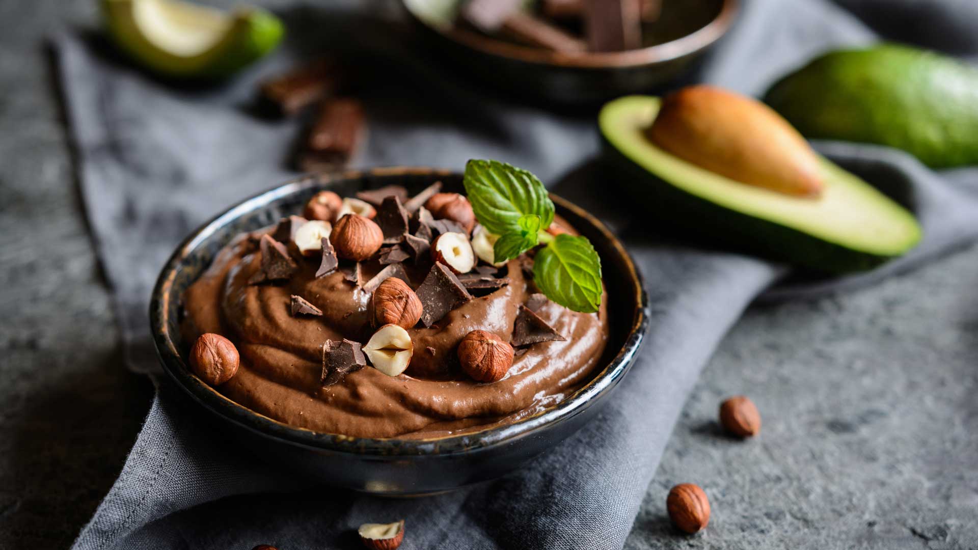 creamy chocolate avocado mousse made with unsweetened hazelnut milk and hazelnuts on top
