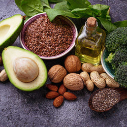 fresh avocados, nuts, and olive oil on a counter