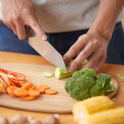 a woman cutting vegetables