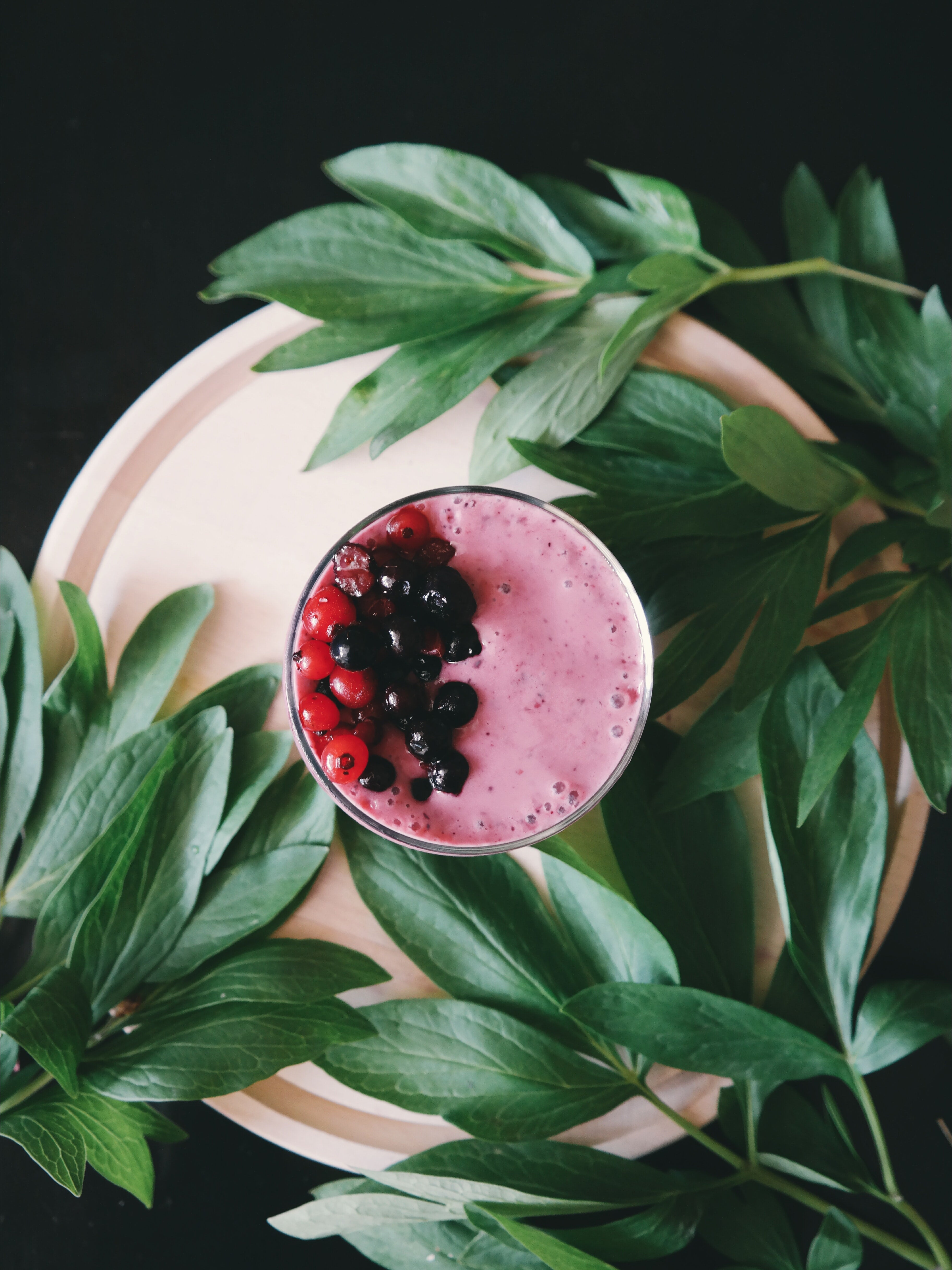 mixed berry smoothie with mixed berries on top made with plant milk