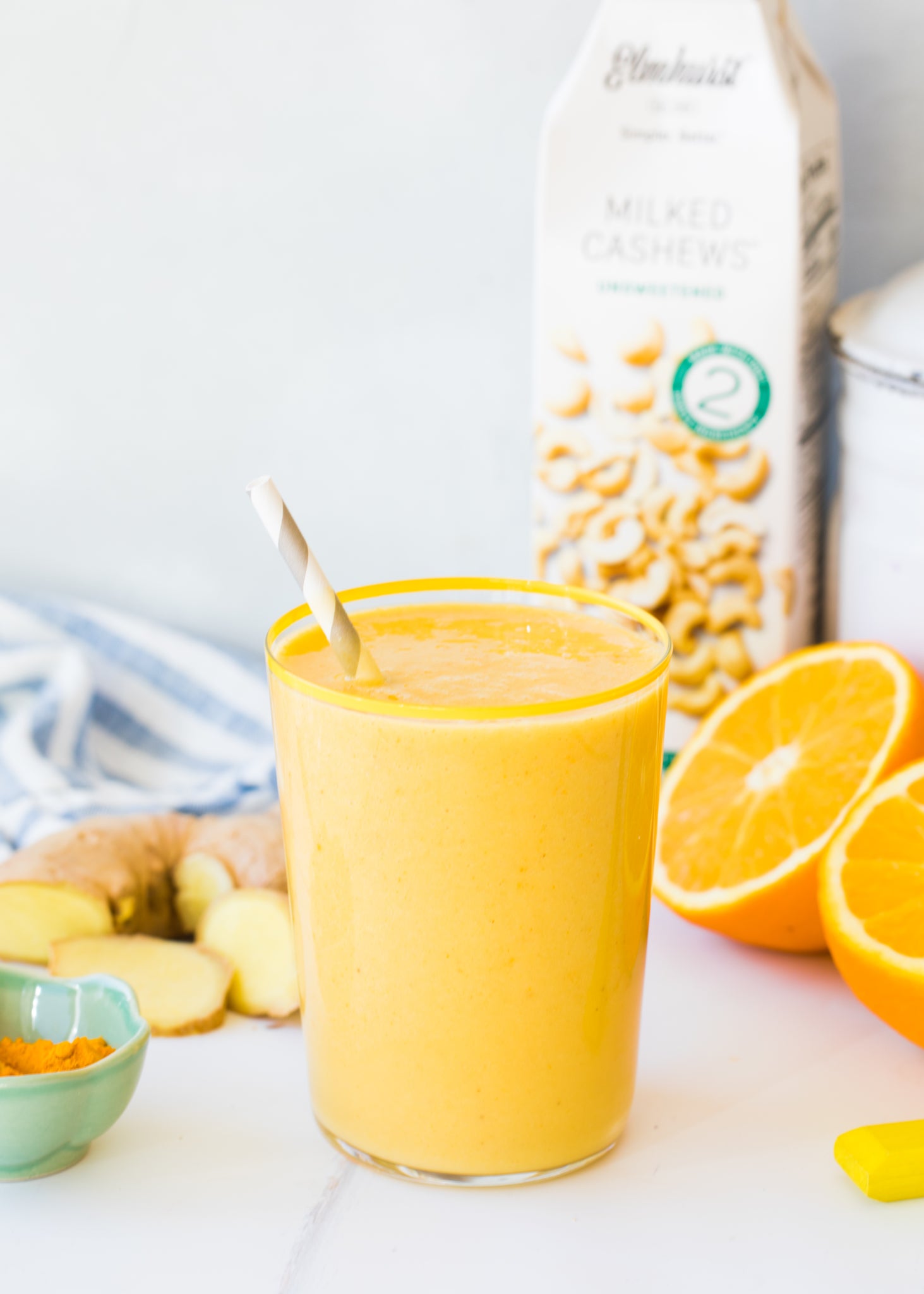 orange ginger turmeric smoothie with mango and cashew milk