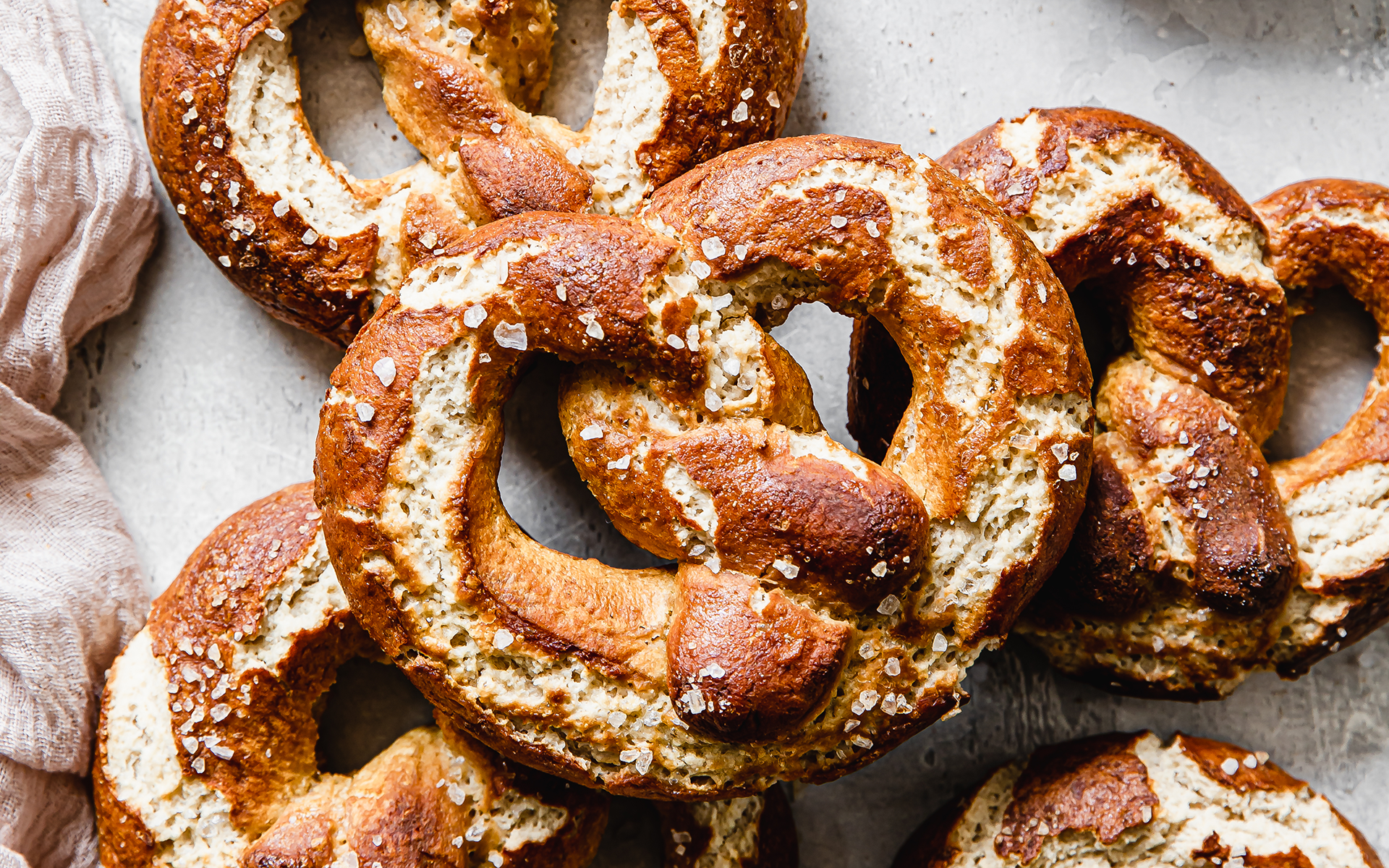 someone holding a vegan soft pretzel