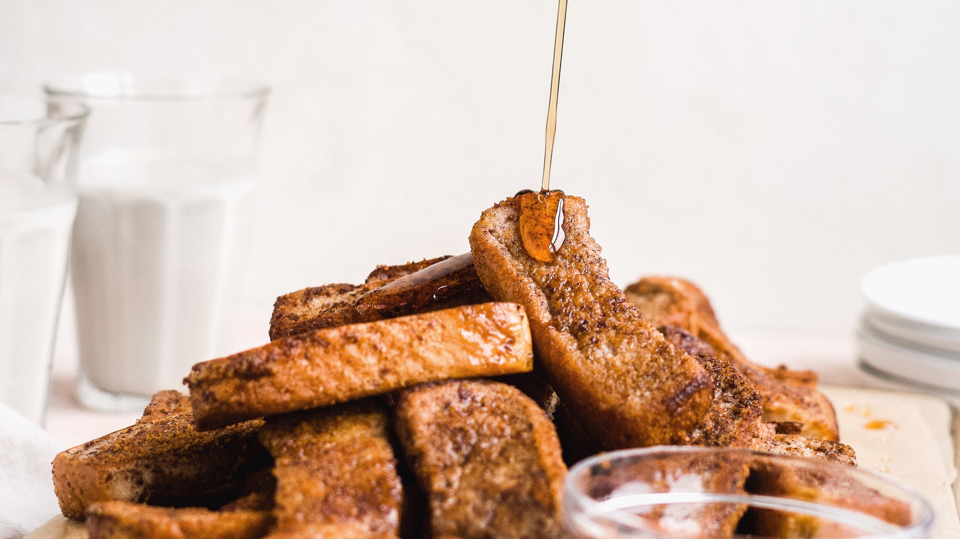vegan french toast sticks drizzled with maple syrup