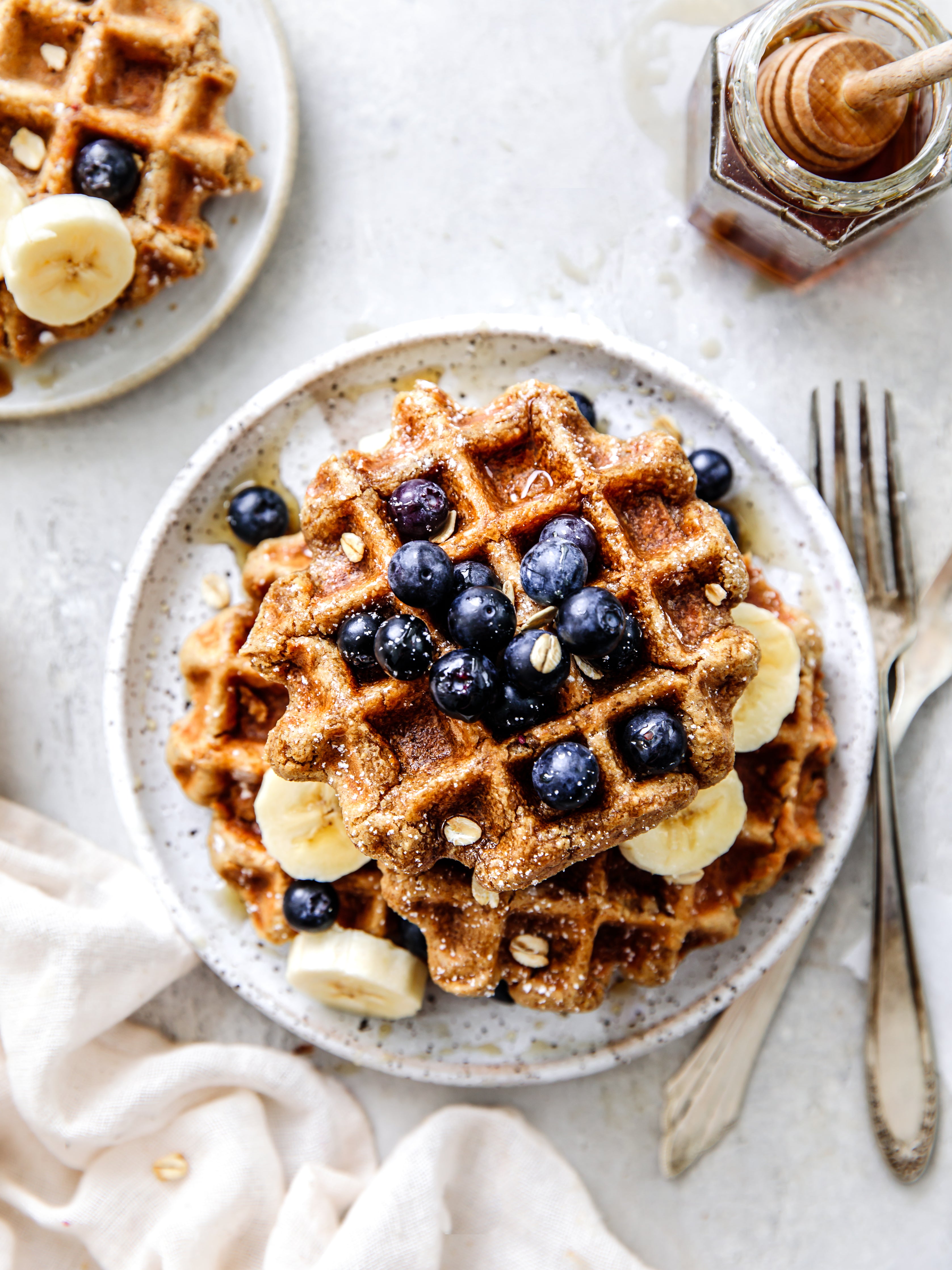 vegan and gluten free waffles topped with bananas and blueberries