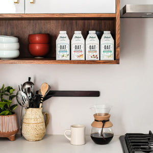 Elmhurst's varieties of oat milk creamers displayed on a shelf